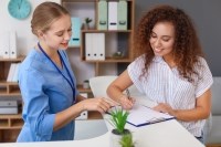 Medical professional advising a patient in a doctor's office.
