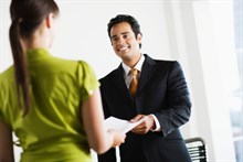 Photo of a person handing in resume